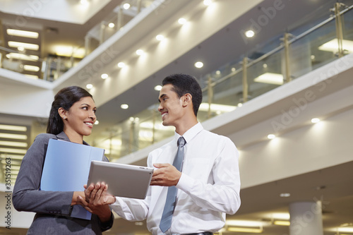 Business partners discussing by using tablet