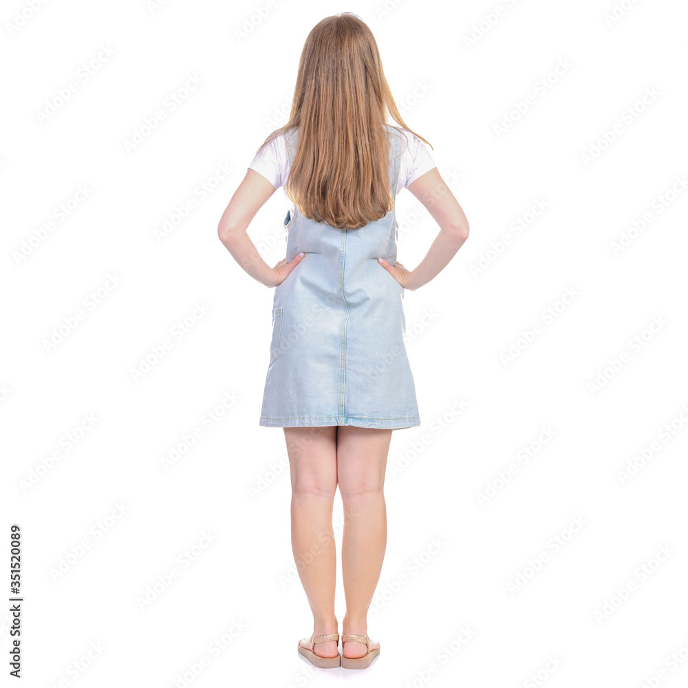 woman in denim sundress standing looking on white background isolation, back view woman in denim sundress standing looking on white background isolation, back view