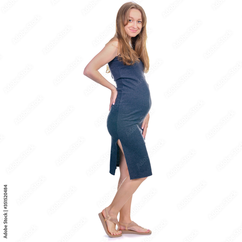 Pregnant woman in dress standing looking smiling on white background isolation Pregnant woman in dress standing looking smiling on white background isolation