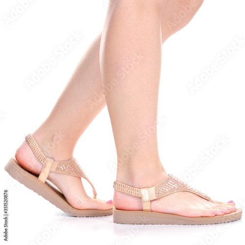 Female legs with pink sandals on white backgound isolation