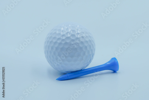Golf ball with tee on white background