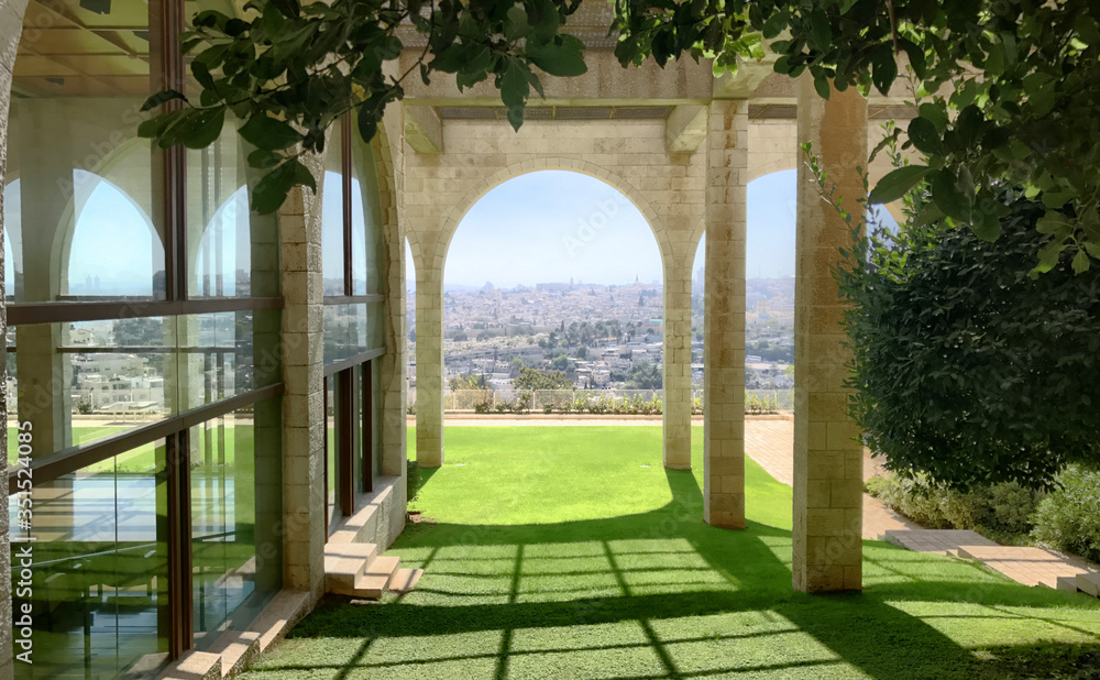 Fototapeta premium Beautiful architectural brick arch on a sunny day, overlooking the city of Jerusalem, Israel
