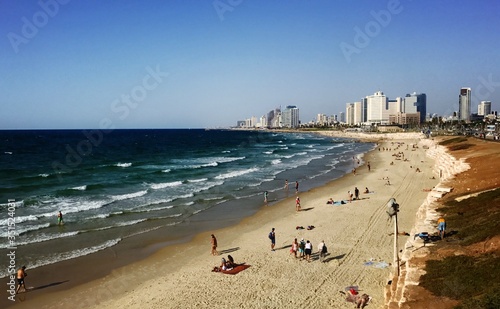Israeli beach goers at the Waterfront Promenade with Tel Aviv's skyline in the background © ahsg