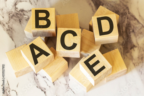 Letters of the alphabet on wooden blocks and a light background photo