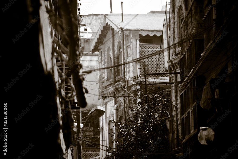 Black and white photos of wires hanging between houses