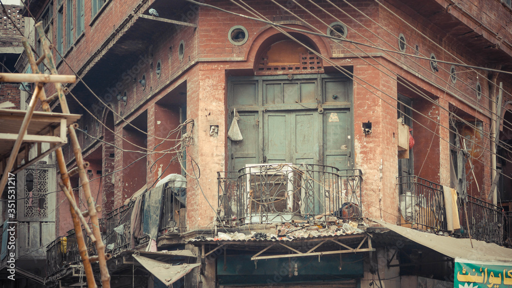 Brick wall with green door and telephone wires