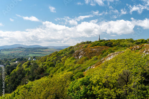Scenic Irish hill landscape on a summer day as seen from Dalkey Hill, Dublin, Ireland with the iconic Killiney Obelisk in the distance,