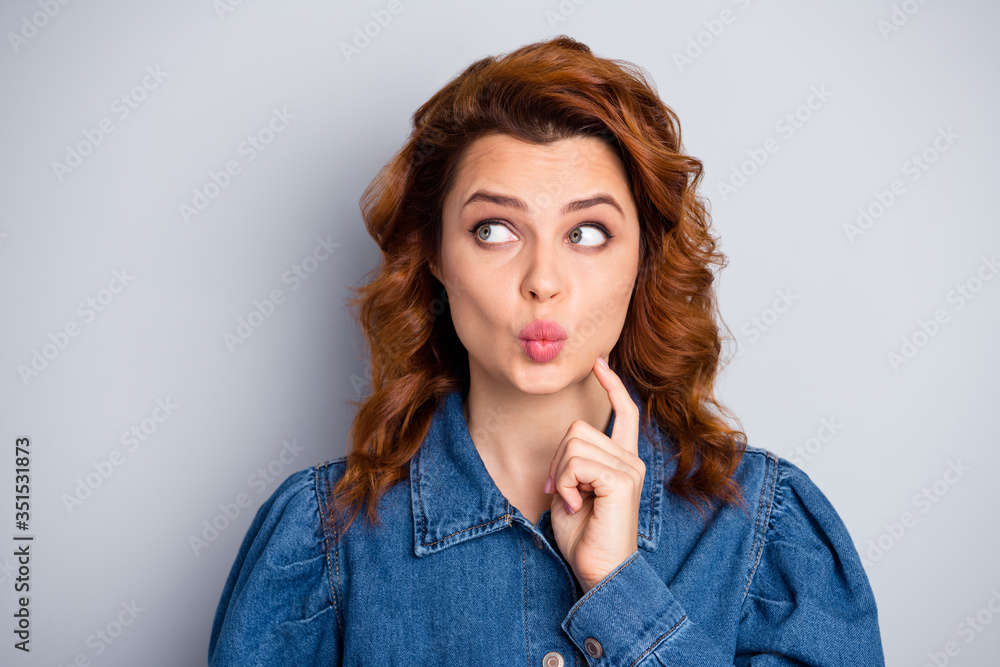 Closeup photo of attractive wavy lady look up empty space dreamer think over creative idea arm chin send shy air kiss wear casual blue jeans denim shirt isolated grey color background