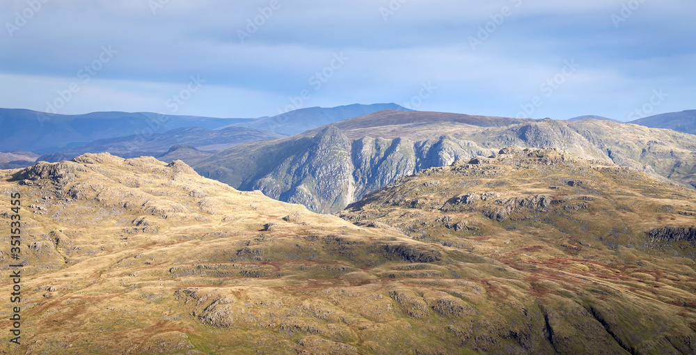 Views of Langdale Pikes and Pavey Ark from Prison Band below Swirl How on a sunny day in the Lake District.