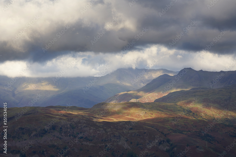 The summits of Crinckle Crags in the cloud, Bow Fell and Harison Stickle to the right in the Lake District. The summits of Crinckle Crags in the cloud, Bow Fell and Harison Stickle to the right in the Lake District.