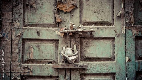 Green door with white fabric as lock © Oz Rao