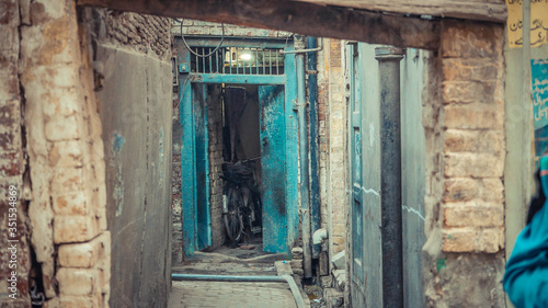 Green opened door at the endof an alleyway © Oz Rao