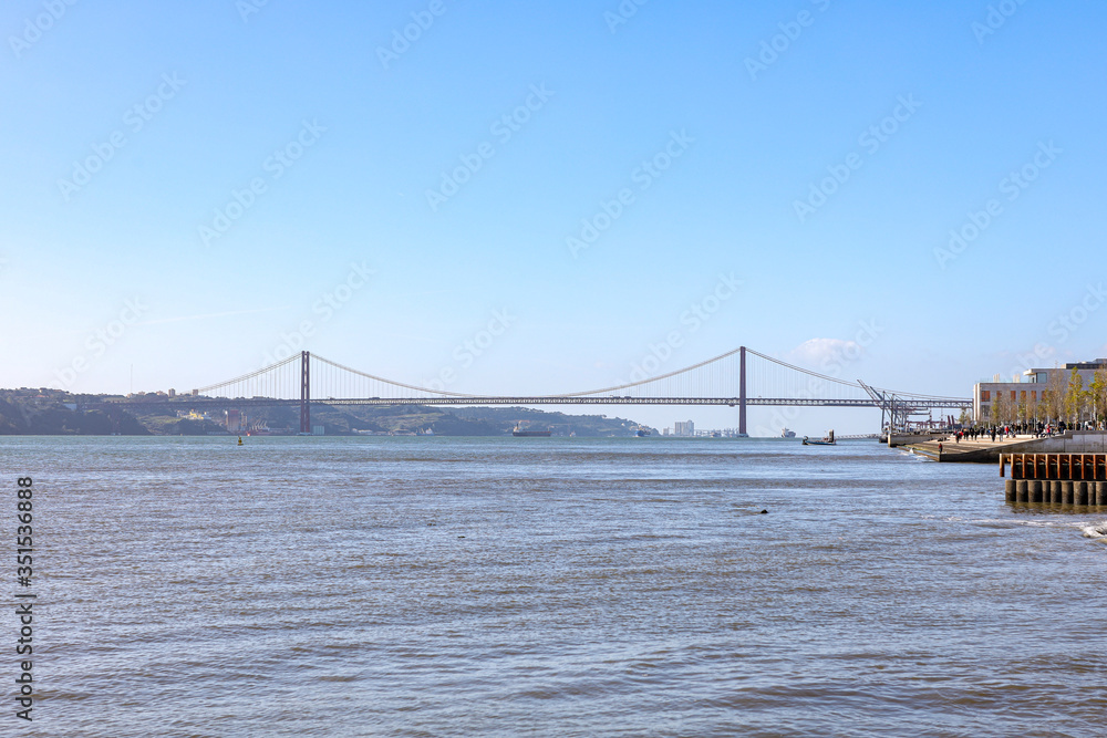 Naklejka premium Beautiful iron cross across the river in Portugal. 25th of April bridge in Lisbon
