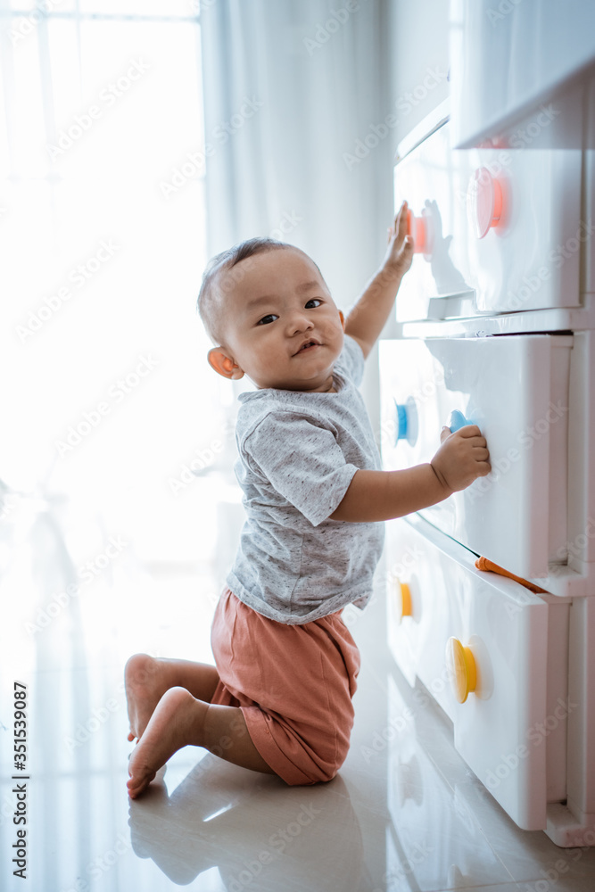 little boy explore his bedroom playing with clothes cabinet little boy explore his bedroom playing with clothes cabinet