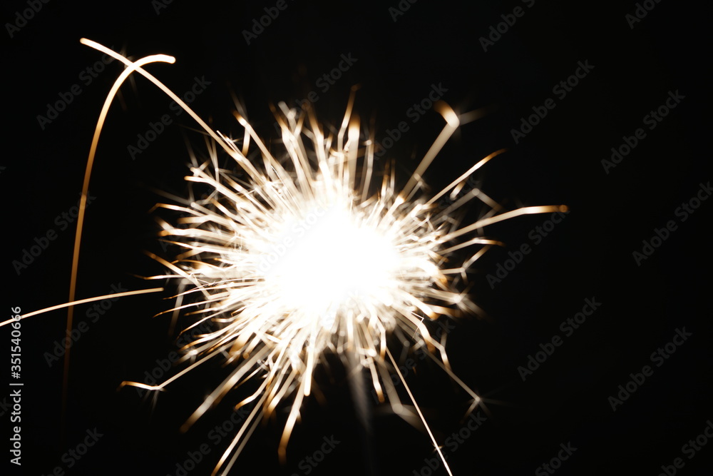 sparklers blurry in bokeh on a black background