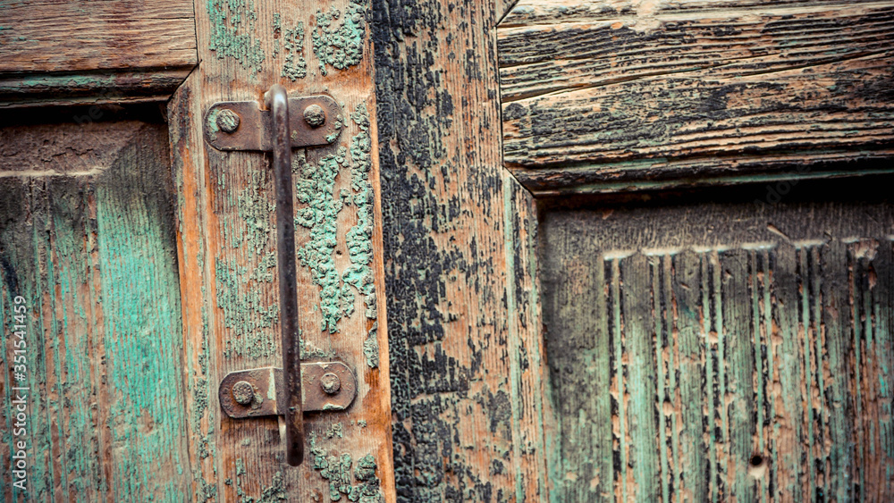 Rusty metal handlebar on the green door Rusty metal handlebar on the green door