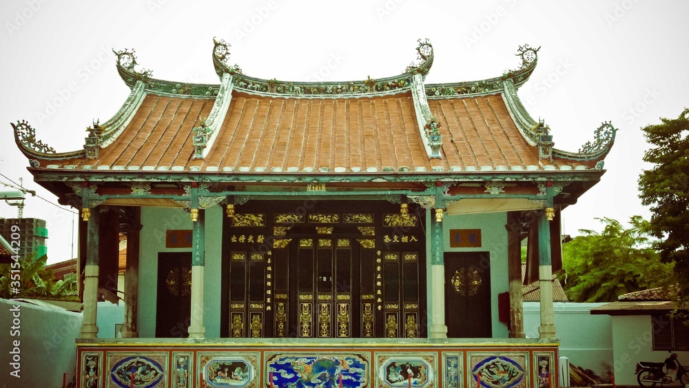 Temple building with brown roof with white wall