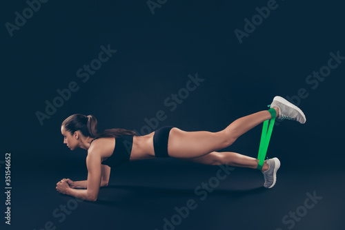 Profile side view portrait of her she nice-looking attractive sportive adorable purposeful slim thin lady working out self motivation regime isolated over black background