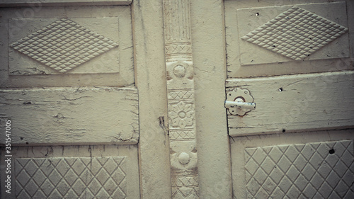 White wooden surface with different carving on © Oz Rao