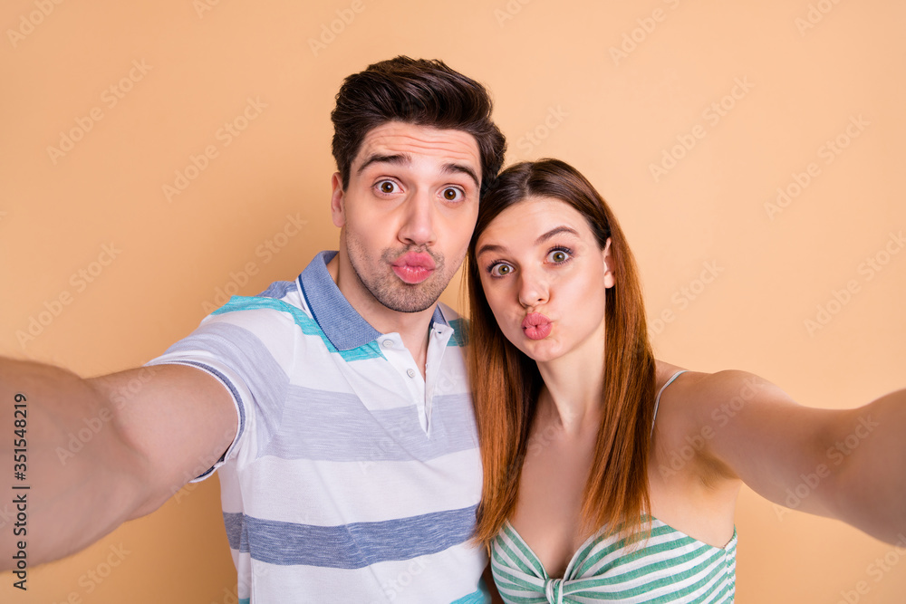 Self-portrait of his he her she nice attractive lovely pretty cute funny playful cheerful cheery couple pout lips having fun isolated over beige pastel color background Self-portrait of his he her she nice attractive lovely pretty cute funny playful cheerful cheery couple pout lips having fun isolated over beige pastel color background