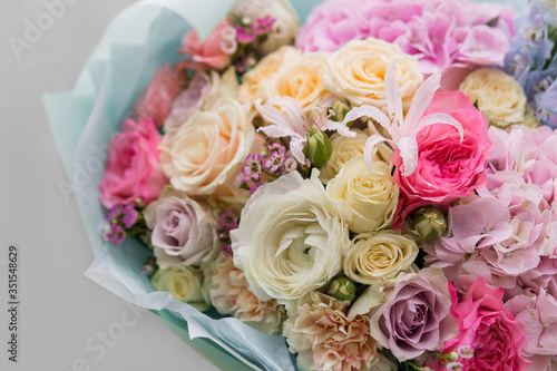 Bouquet with ranunculus  roses  cloves close up. Florist shop. Flowers.