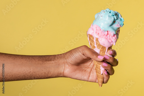 Hand holding a melting ice cream photo