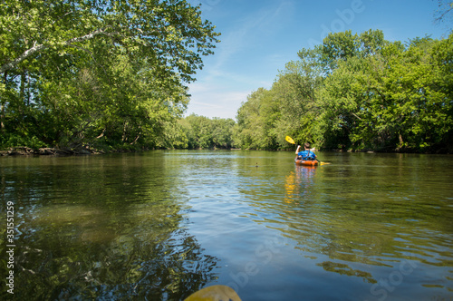 Summer paddle down a calm stretch of river.