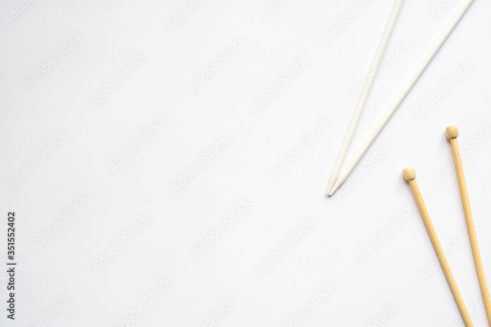 top view of knitting needles on white background top view of knitting needles on white background