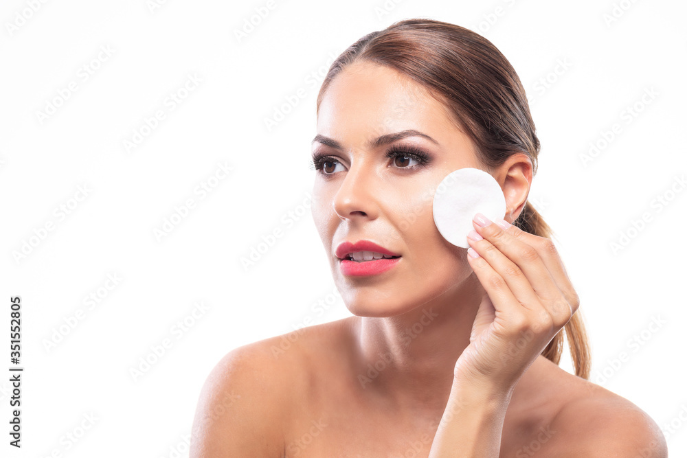 Portrait of a cute lady removing makeup