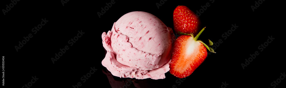delicious pink strawberry ice cream with fresh berries isolated on black, panoramic orientation delicious pink strawberry ice cream with fresh berries isolated on black, panoramic orientation