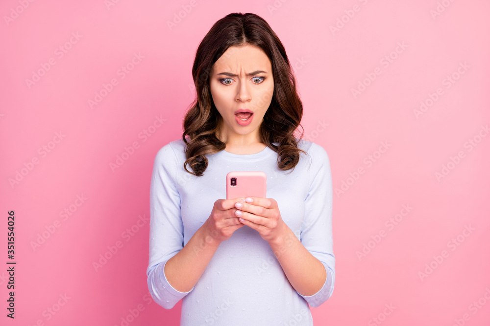 Photo of beautiful attractive lady hold telephone hands quarantine time read news corona virus infection spreading world wear casual white shirt isolated pastel pink color background