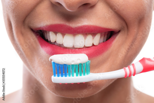 Close up of white teeth and a toothbrush