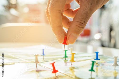 The red pin in the hand, focus on the map, travel to the desired target position