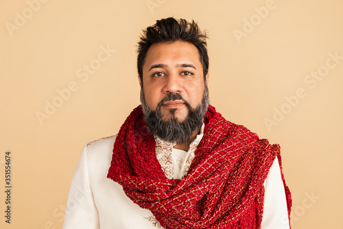 Indian man wearing a kurta with a red scarf photo