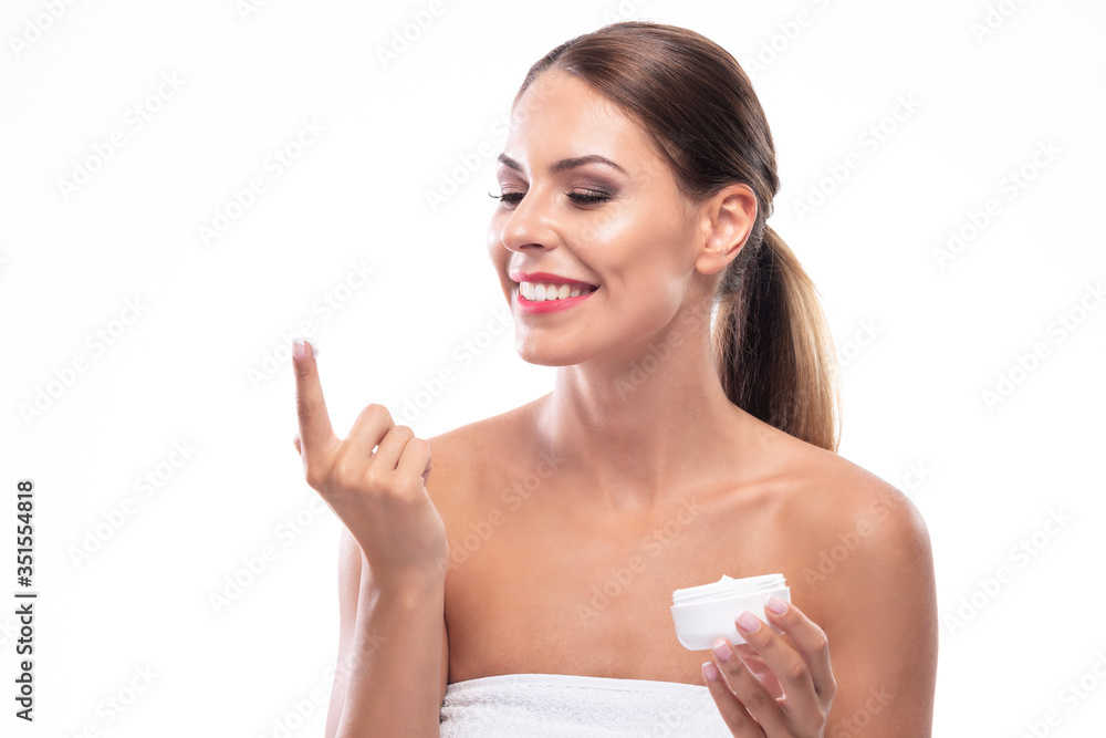 Happy sexy brunette woman applying moisturizing cream on her body Happy sexy brunette woman applying moisturizing cream on her body