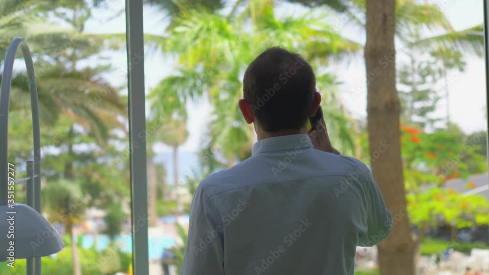Businessman Talking On The Phone In The Tropics in 4k slow motion 60fps