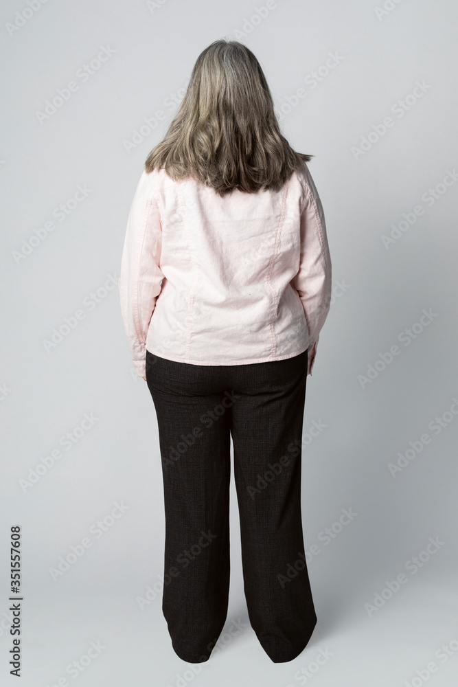 Rear view of a senior woman in studio shoot Rear view of a senior woman in studio shoot