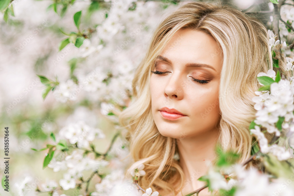 portrait of a woman in a blooming garden. portrait of a woman in a blooming garden.