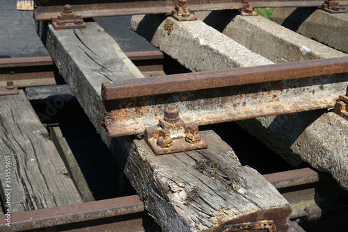 Hardened steel railroad tracks photographed on a sunny spring day photo