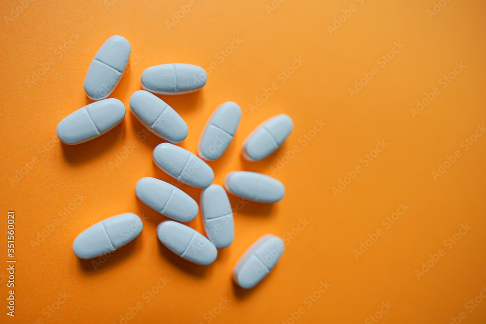 White pills on a colorful background with a free area for text White pills on a colorful background with a free area for text