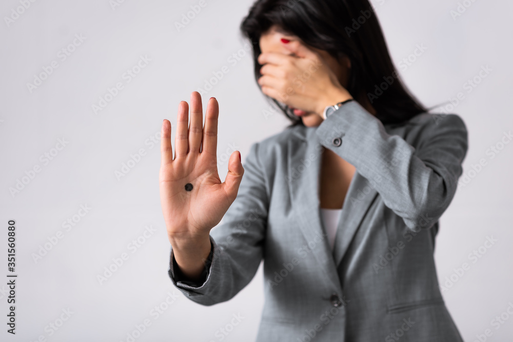 selective focus of businesswoman with black dot on palm covering face isolated on white, domestic violence concept selective focus of businesswoman with black dot on palm covering face isolated on white, domestic violence concept
