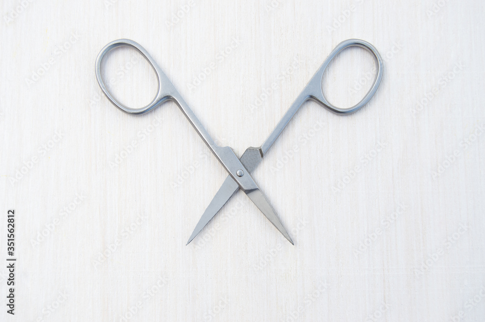 Nail scissors for manicure on a white background. Top view. Nail scissors for manicure on a white background. Top view.