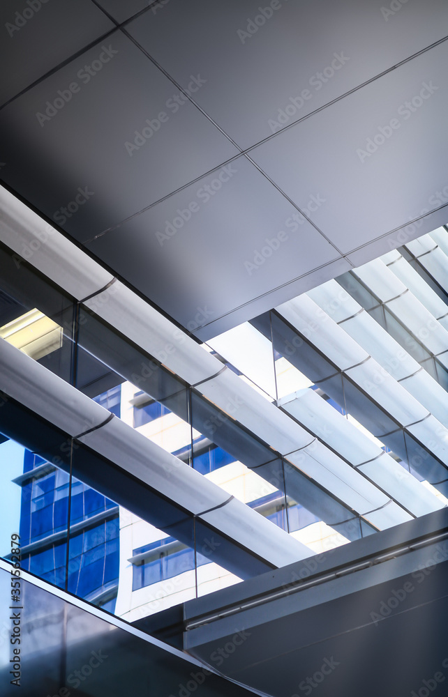 generic and minimal view of windows with sky reflection of a modern design building, all identifiable or unique elements were avoided in the shot generic and minimal view of windows with sky reflection of a modern design building, all identifiable or unique elements were avoided in the shot