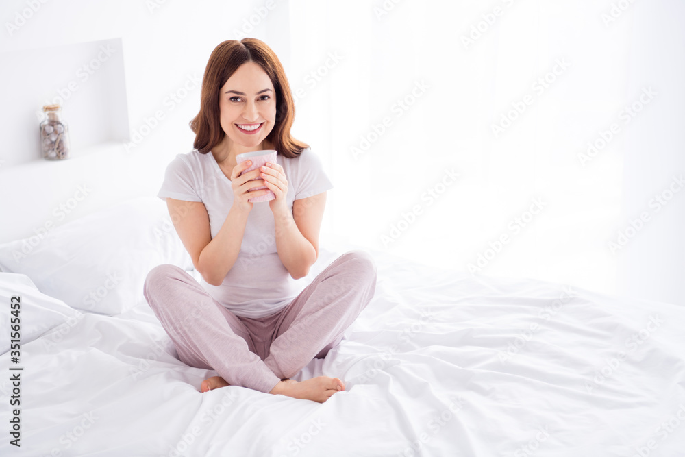 Portrait of her she nice attractive lovely cheerful cheery red haired girl sitting in bed enjoying drinking hot sweet cacao in modern white light interior style room house apartment Portrait of her she nice attractive lovely cheerful cheery red haired girl sitting in bed enjoying drinking hot sweet cacao in modern white light interior style room house apartment
