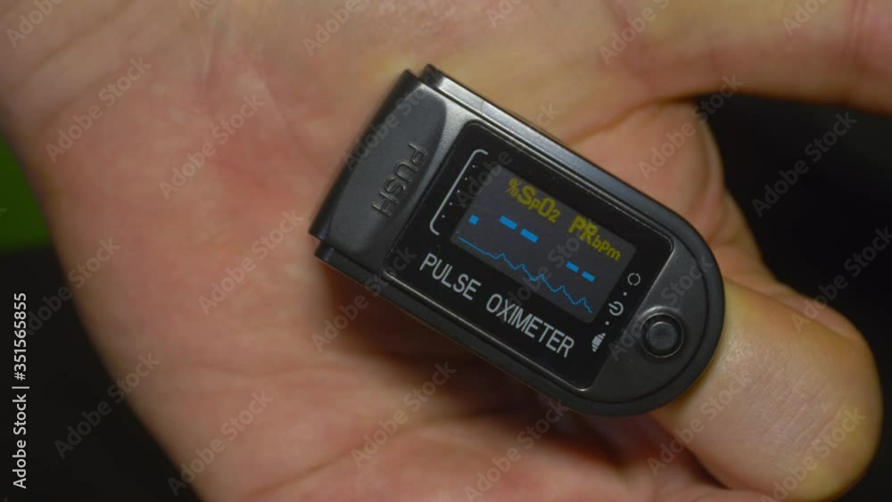 Pulse oximeter O2 saturation at 98% during patient test in index finger Pulse oximeter O2 saturation at 98% during patient test in index finger
