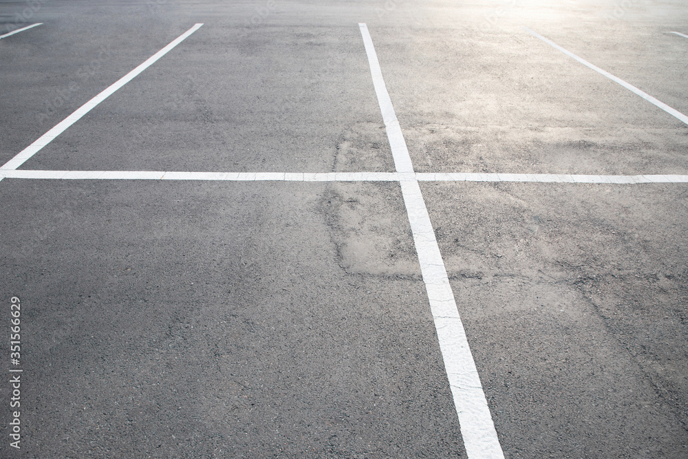Empty parking lot car, marked with white lines. 