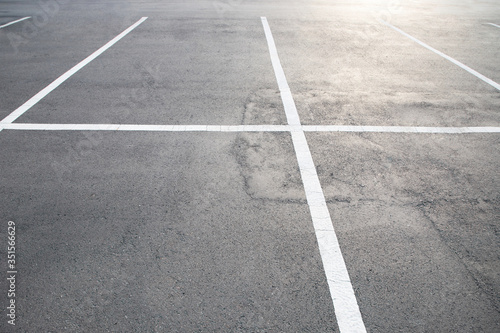 Empty parking lot car, marked with white lines.  © methaphum