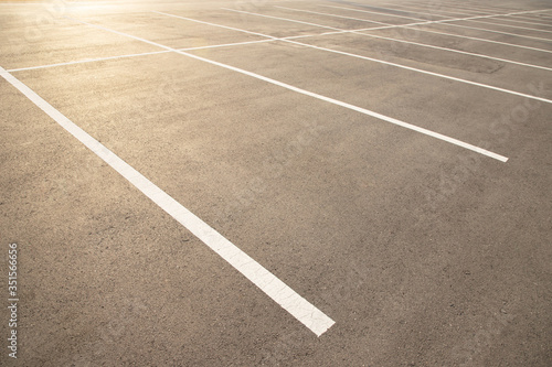 Empty parking lot car, marked with white lines.  © methaphum