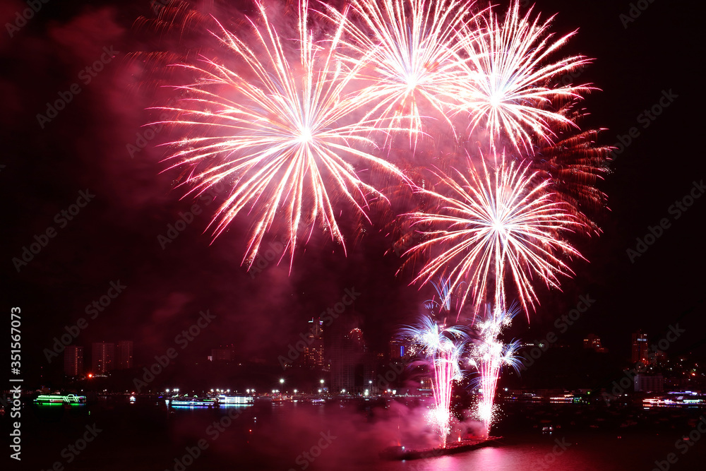 Fantastic red fireworks splashing in the night sky over the harbor Fantastic red fireworks splashing in the night sky over the harbor