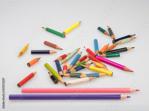 Colored pencils. Short and long sharpened pencils on a white background.